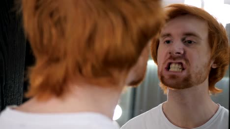 Redhead-Beard-Man-Looking-at-His-Face-in-Mirror