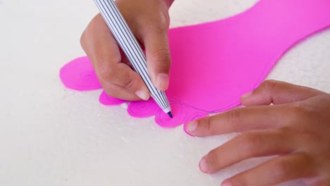 Close-up-kid-hands-using-the-colored-felt-pens-on-paper,-slow-motion-shot-in-50-fps