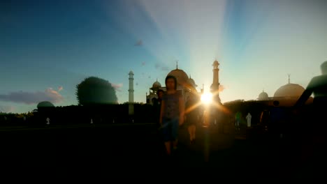 Taj-Mahal-with-tourists-walking-against-beautiful-sunset,-4K