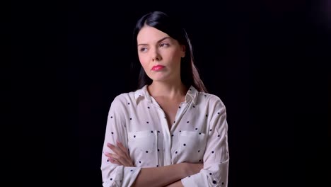 Thoughtful-young-woman-thinking-and-nodding,-isolated-on-black-background,-beautiful-brunette-lady-in-shirt