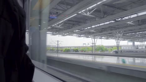 High-Speed-Bullet-Train-Departing-from-Station-Interior-View-Sunlight