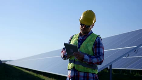 Elektrischen-Arbeiter-Tippen-auf-seinem-Tablet-außerhalb