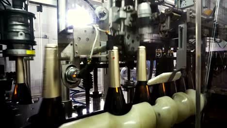 The-line-for-filling-and-sealing-the-conveyor-in-a-factory-of-champagne