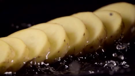 Falling-of-sliced-potatoes-into-the-wet-table.-Slow-motion-480-fps