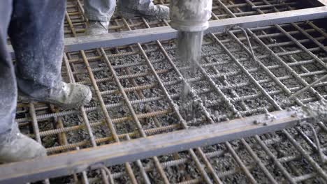 A-group-of-builders-poured-concrete.-The-foundation-of-a-large-construction-site,-the-builders-are-building-a-skyscraper-or-factory