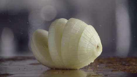 Falling-of-sliced-white-onion-into-the-wet-table.-Slow-motion-240-fps