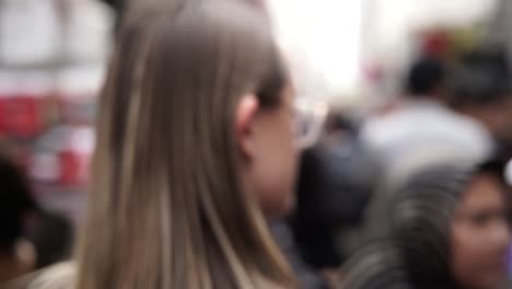 junge-kaukasische-Touristen-Frau-zu-Fuß-durch-beschäftigt-Straßenmarkt-in-Hong-Kong