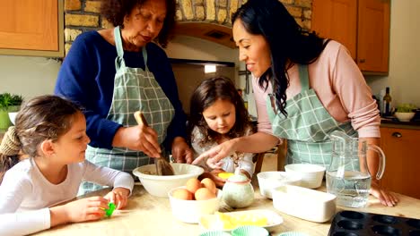 Siblings-preparing-food-with-family-in-kitchen-4k