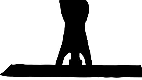 Silhouette-Beautiful-young-woman-doing-yoga-exercise-variation-of-supported-headstand,-garuda-salamba-sirsasana-with-crossed-legs