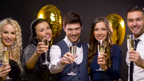 happy-friends-with-champagne-glasses-at-party