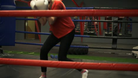 A-young-girl-in-a-helmet-and-boxing-gloves-trains-slopes