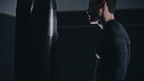 fit-boxer-training-on-a-punching-bag-in-an-indoor-boxing-studio