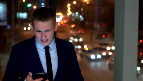 The-man-is-a-businessman,-looking-at-the-smartphone-and-angry,-trying-to-contain-anger.