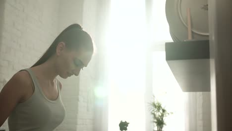 Beautiful-Young-Woman-At-Light-Sunny-Kitchen-In-Morning