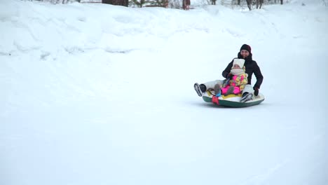 Mother-and-Daughter-Riding-on-a-Sledding-Tubing