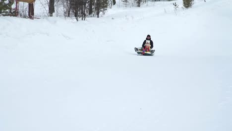 Mother-and-Daughter-Sliding-Down-on-a-Tube