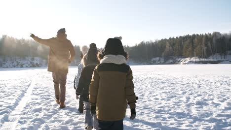 Family-Walking-in-Bright-Sunshine-in-Winter