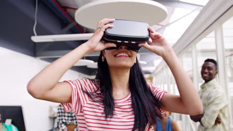 Female-creative-using-VR-goggles-in-a-modern-office