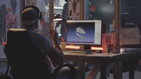 Man-modeling-dinosaur-skull-on-computer