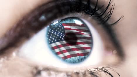 woman-blue-eye-in-close-up-with-the-flag-of-USA-in-iris-with-wind-motion.-video-concept