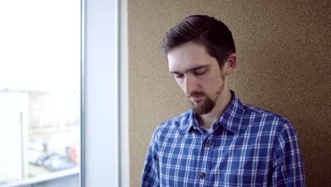 Pensive-man-looking-through-the-window