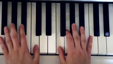 Playing-piano-in-bedroom,-Top-view,-Hand-held