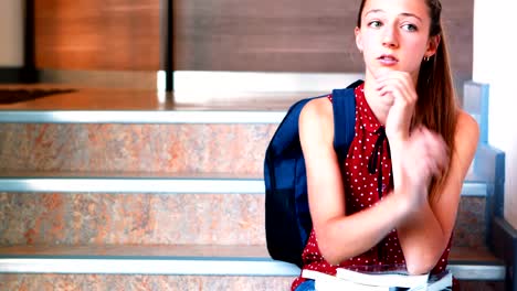 Sad-schoolgirl-sitting-alone-on-staircase