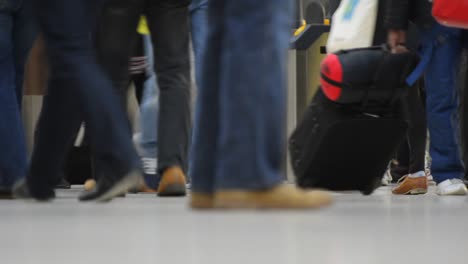 Low-angle-view-of-commuters-and-travelers-moving-through-a-busy-public-space.-High-quality-HD-video-footage,-london,-uk