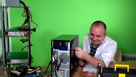 Mad-man-pc-doctor-examining-computer-case-with-stethoscope-and-laughing