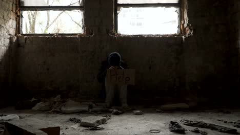 Poor-sick-homeless-with-plate-help-in-abandoned-building