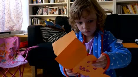 Girl-Playing-With-Halloween-Paper-Cut-Out