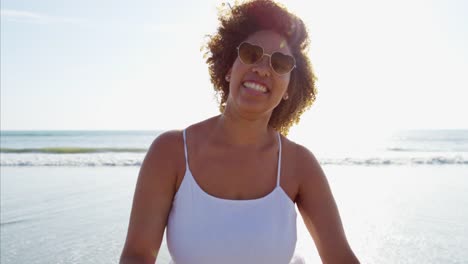 Portrait-of-African-American-female-running-through-waves