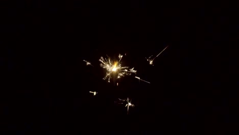 Firework-sparkler-burning-on-black-background-in-slow-motion