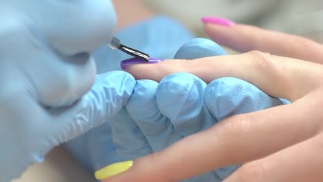 Manicurist-covers-nail-with-fixer-close-up.