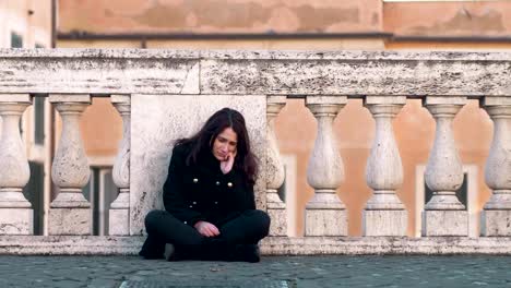 portrait-of-Depressed-lonely-sad-brunette-sitting-in-the-street,-boyfriend-supporting-her.-Loneliness,solitude,sadness