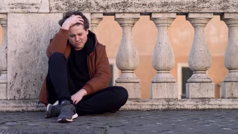 sad-and-worried-young-lonely-man-sitting-in-the-street.-Heartbreak