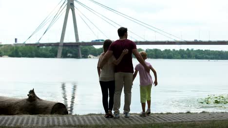 Family-with-kid-looking-at-bridge,-concept-of-immigration-or-moving-to-new-city