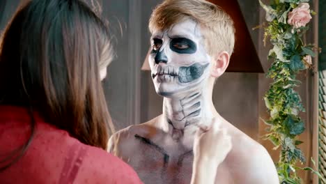 Make-up-artist-makes-the-guy-halloween-make-up.-Halloween-male-face-art.