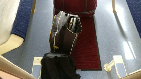 Two-backpacks-and-one-bag-in-an-empty-compartment-cabin-for-four-of-sleeping-car