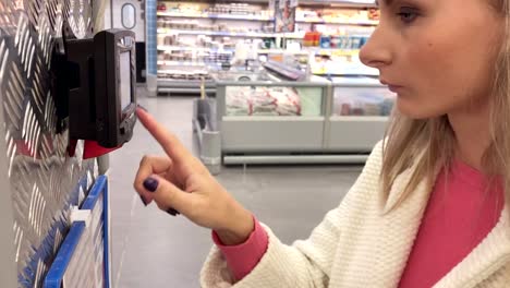 Woman-reads-a-barcode-on-a-product-in-the-supermarket