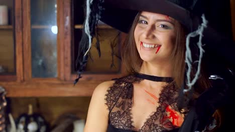 Halloween-witch-raises-her-head-from-under-the-hat-angrily-laughing