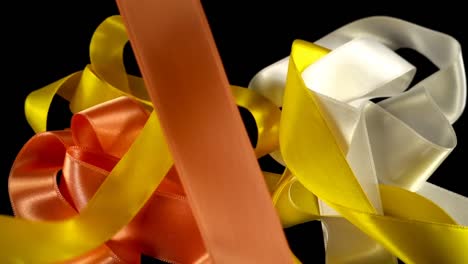 Satin-ribbon-on-a-black-background.-Slow-motion.