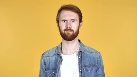 Redhead-Man-Waving-Finger-to-Refuse-Isolated-on-Yellow-Background