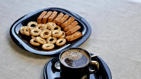 Put-a-cup-of-coffee-on-the-table.-There-is-a-plate-with-homemade-cookies-on-the-table.