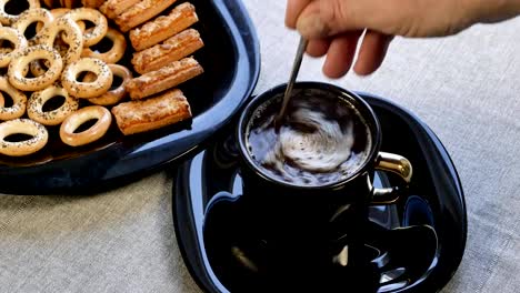 Put-a-cup-of-coffee-on-the-table.-There-is-a-plate-with-homemade-cookies-on-the-table.