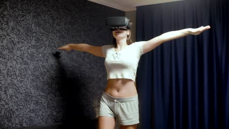 Beautiful-young-woman-wearing-VR-Headset-at-bedroom.-Looking-around-and-represents-what-flies.