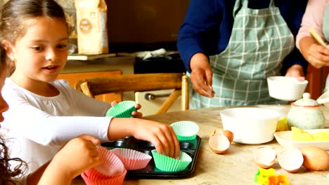 Siblings-preparing-food-with-family-in-kitchen-4k