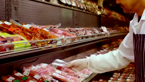 Butcher-arranging-wrapped-meat-in-rack-4k