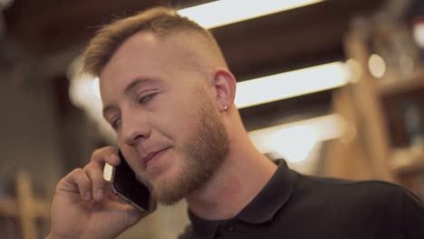 Face-of-a-handsome-bearded-guy-talking-on-the-cellphone.-Portrait-of-a-guy-talking-on-the-mobile.