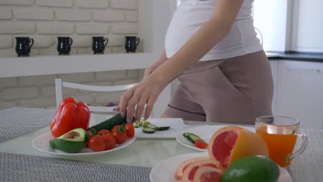 natural-food-for-pregnancy,-maternity-girl-with-big-abdomen-is-cooking-useful-salad-for-healthy-tasty-lunch-from-fresh-vegetables